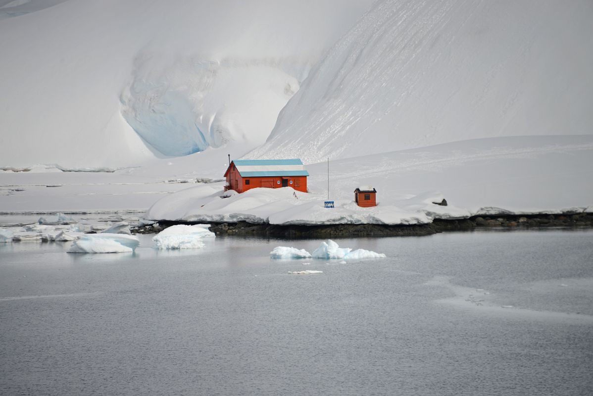 04A Two Buildings At Almirante Brown Station With Snow Covered Hills Behind From Zodiac On Quark Expeditions Antarctica Cruise